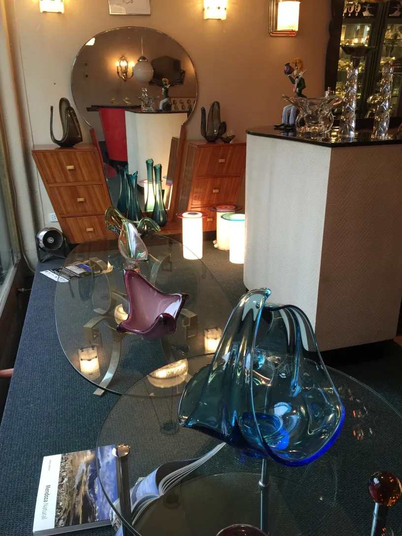 Beautiful antique Murano glass vases in various shapes and colors, enhancing the space's decor.