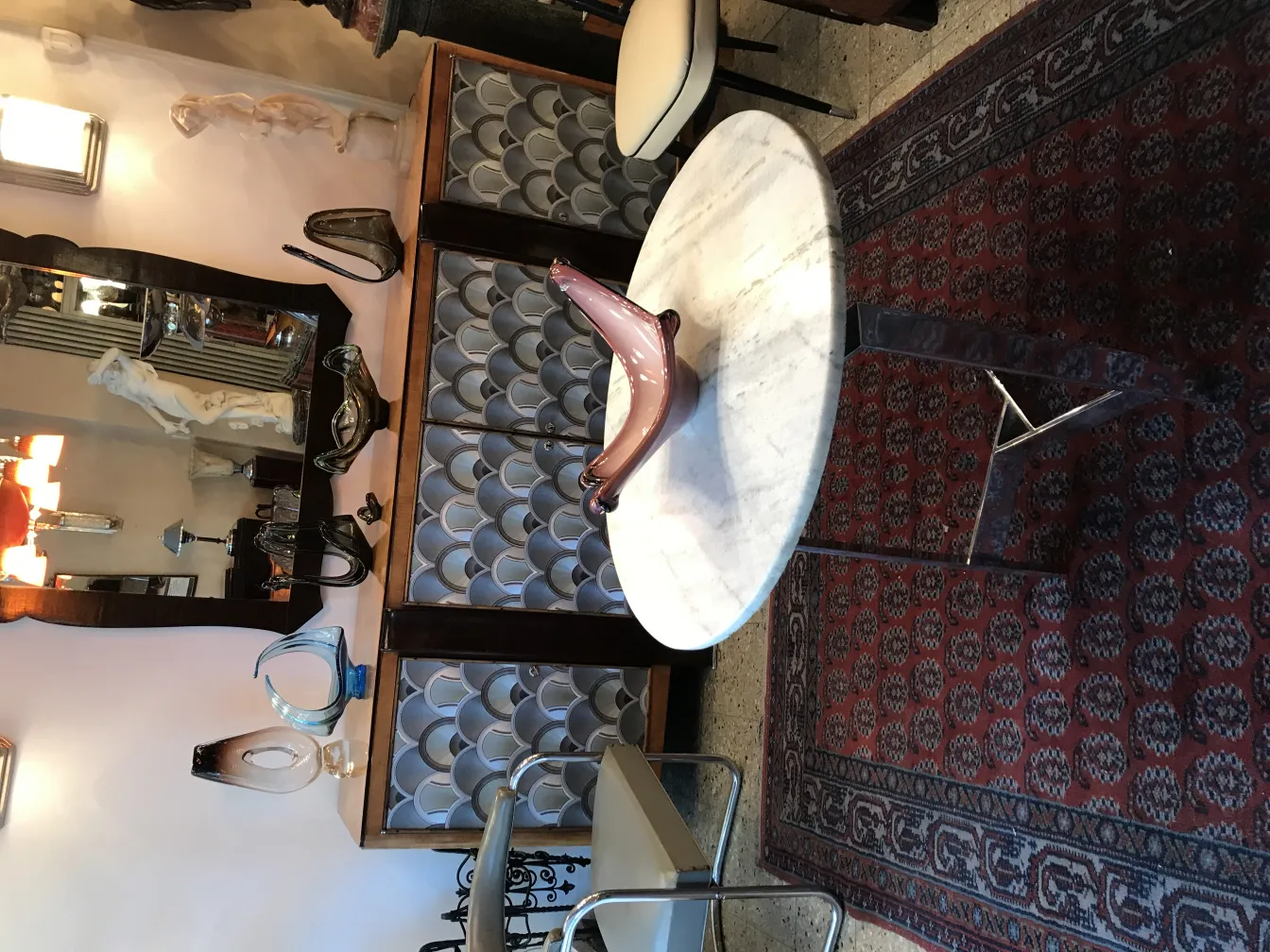 antique murano glass with flowing shapes in a classic setting