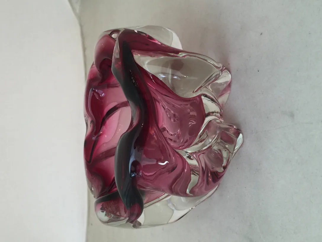 Antique Murano glass with vibrant colors in wave shapes.