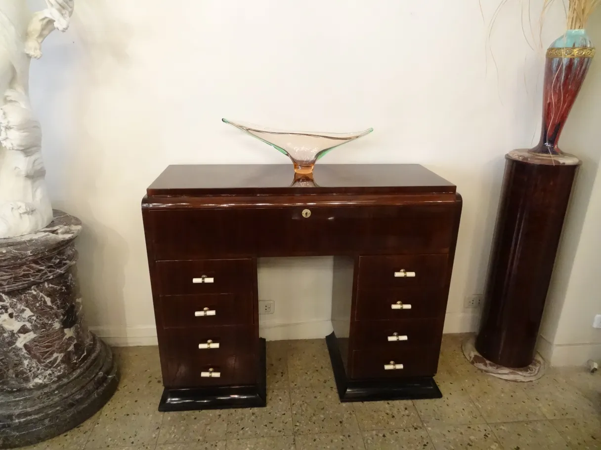 murano glass adornment on an antique desk with drawers