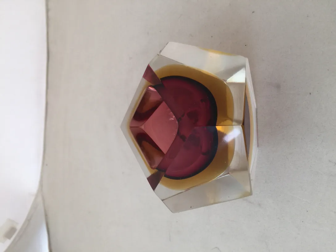 interesting antique murano glass item with hexagonal shape and vibrant colors on a light background