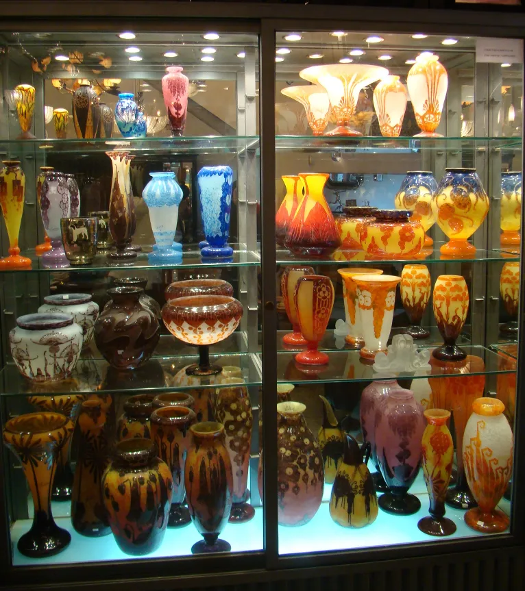Collection of decorative antique glass displayed on a shelf