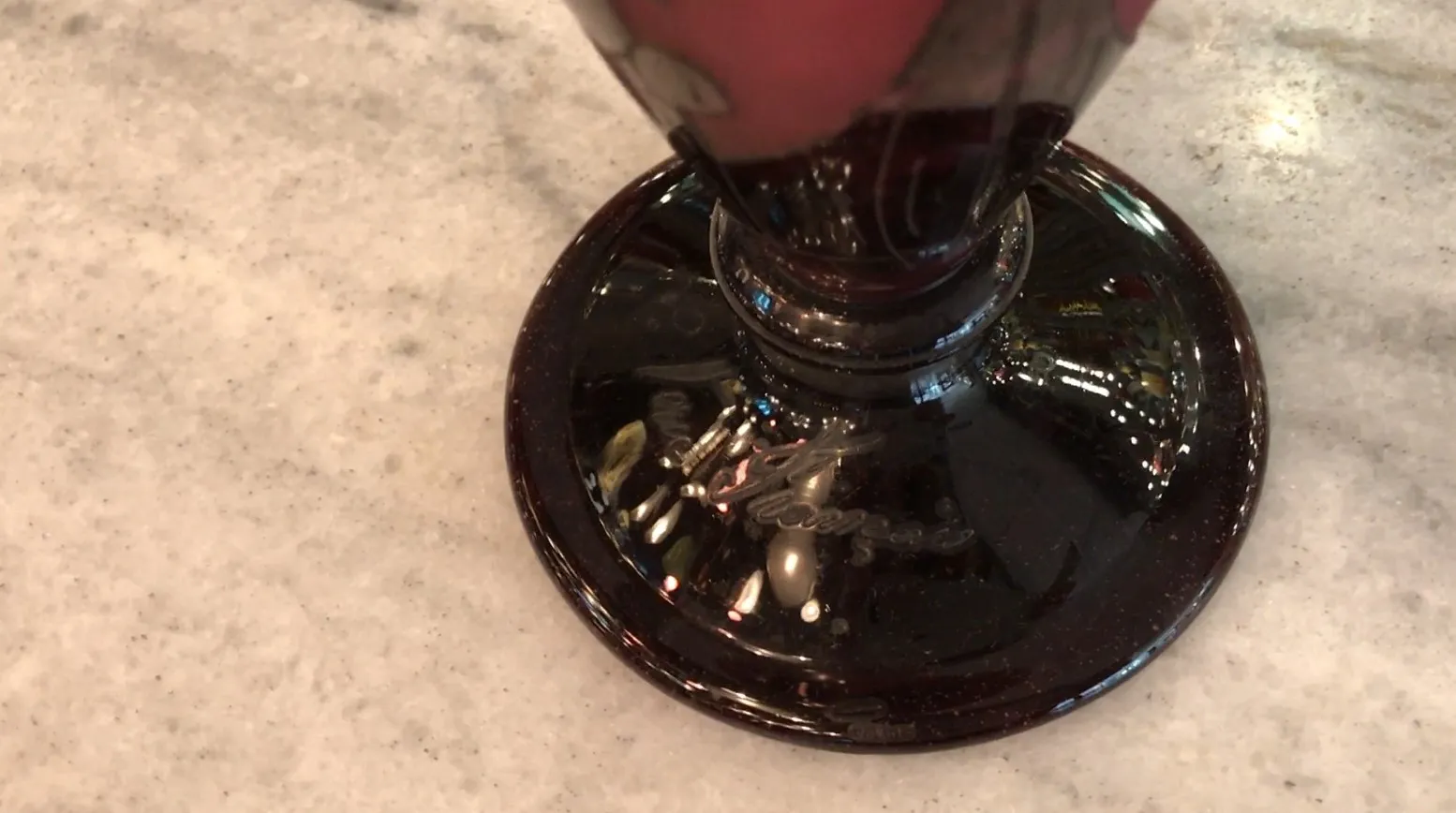 signed glass featuring detailed base and subtle decorations