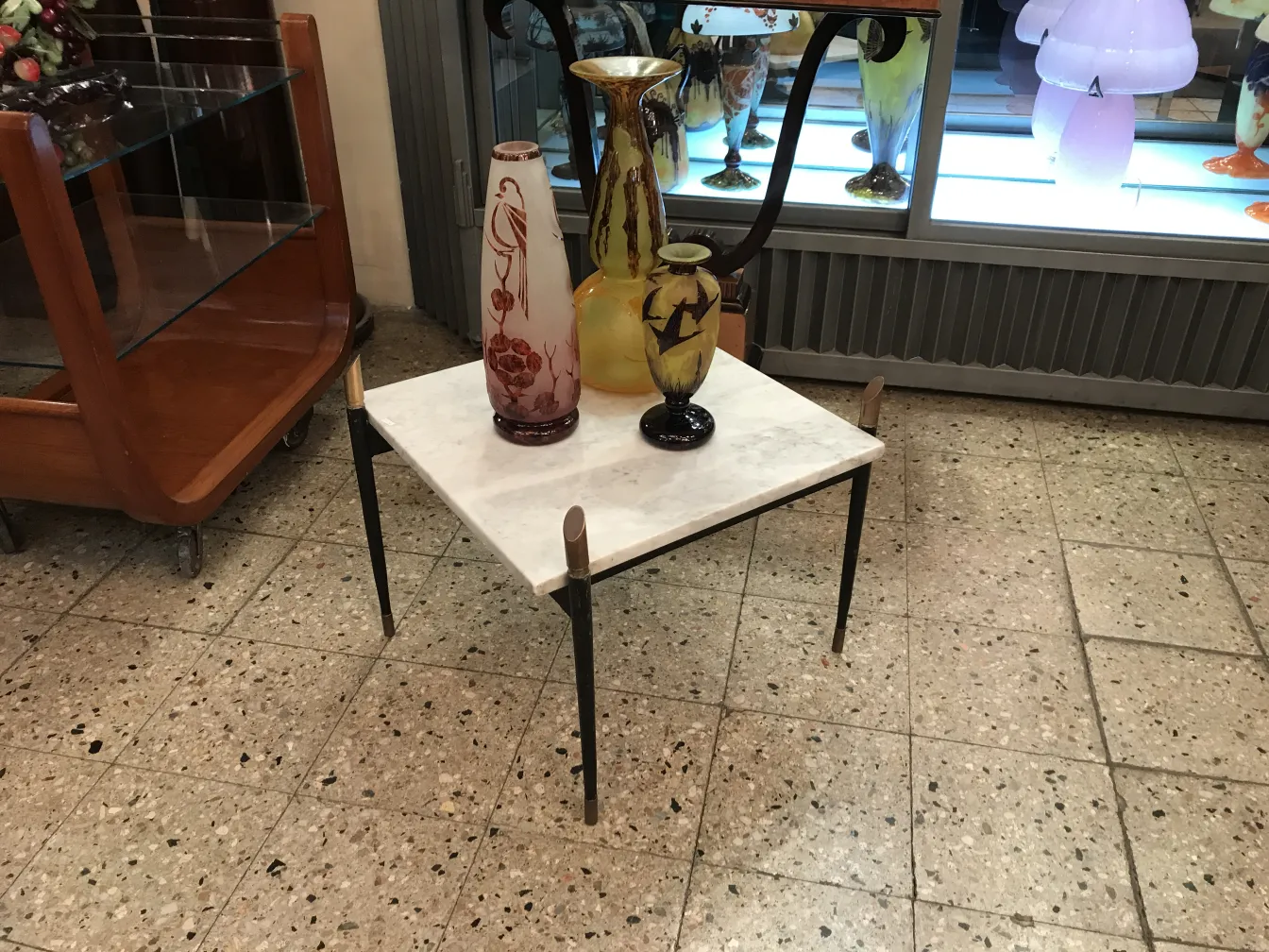 Signed glass Le Verre displayed on a table with decor.