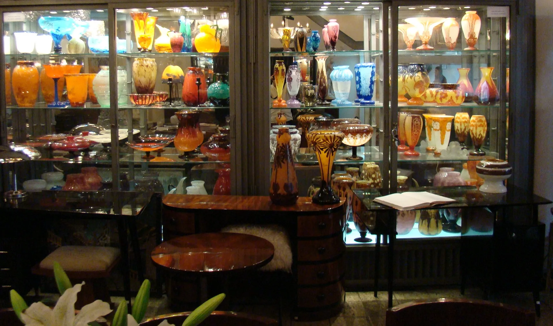 a display case with antique signed glass items