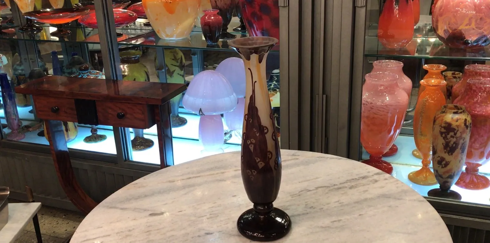 Glass vase with signature in a colorful antique display