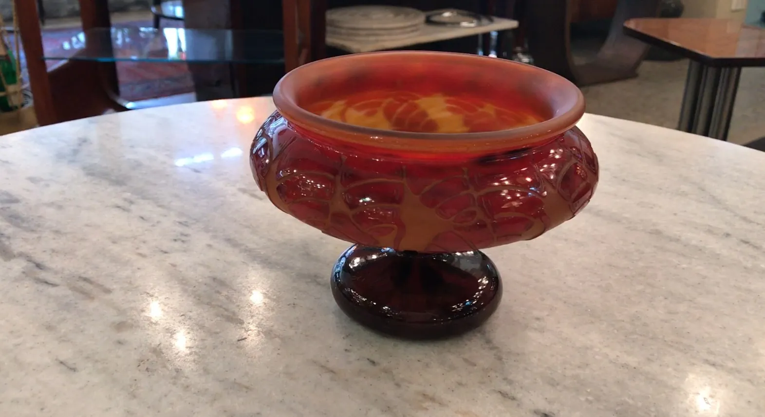 round glass piece in warm colors with intricate design