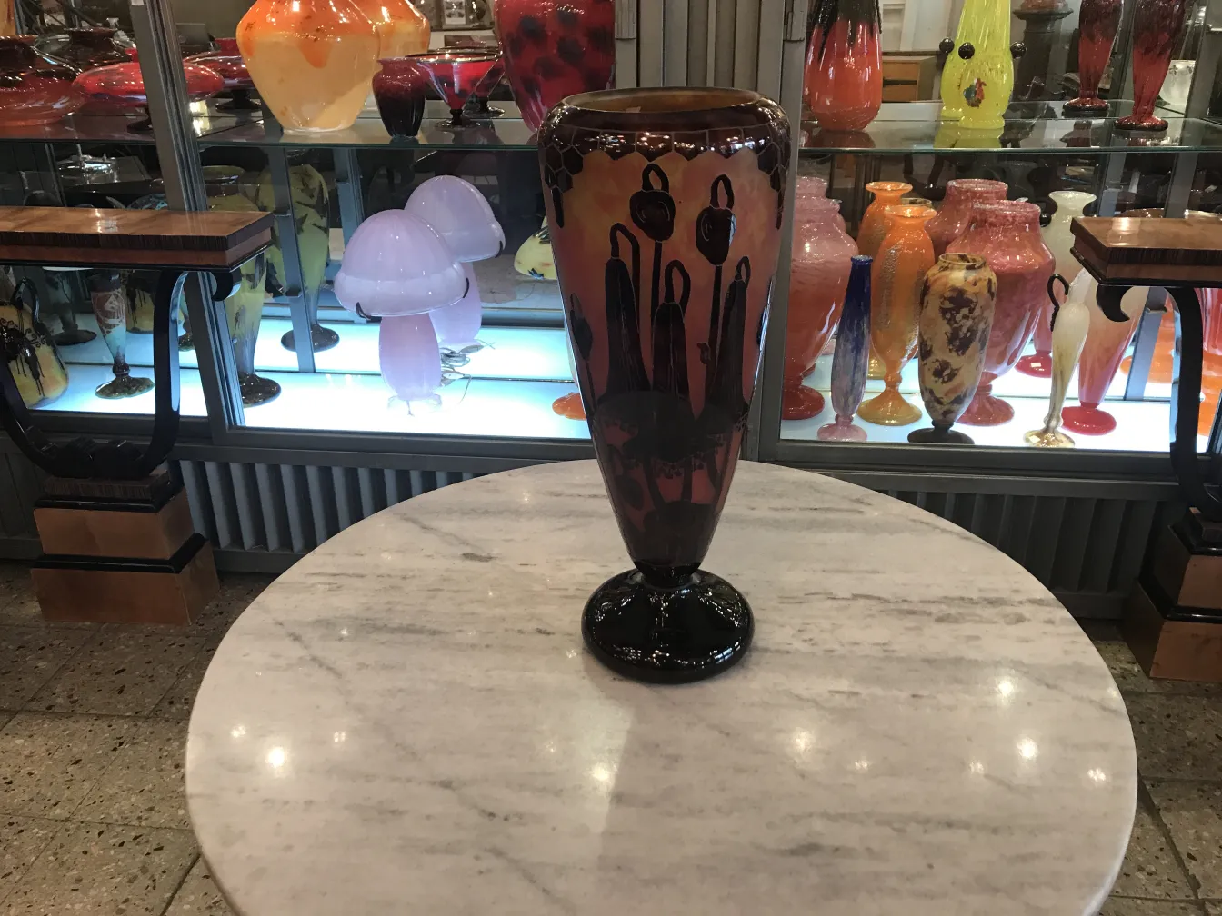 Antique vase with floral design in vibrant colors, cozy setting.