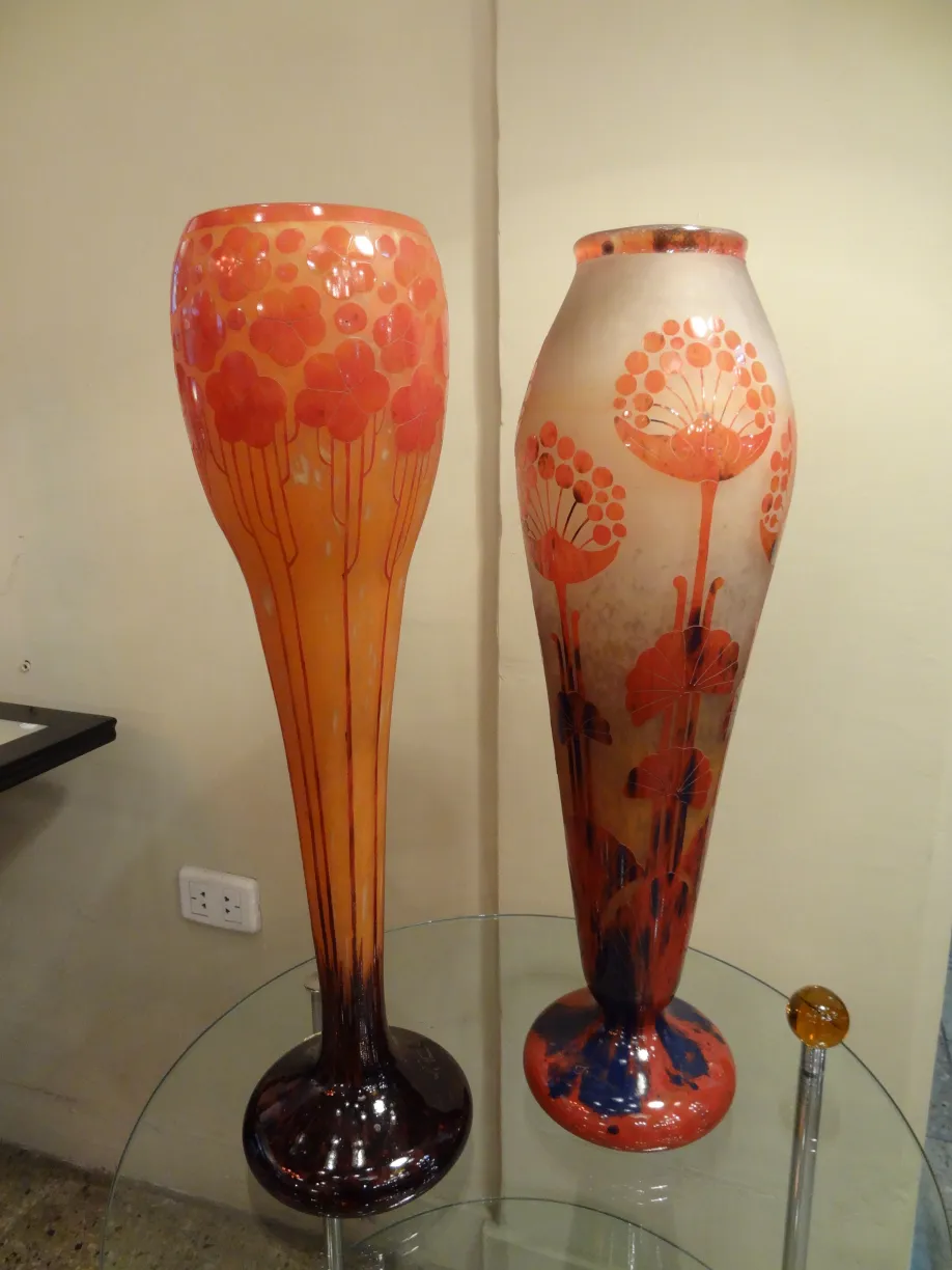 Two antique vases of signed glass Le Verre with floral design in orange and red colors.