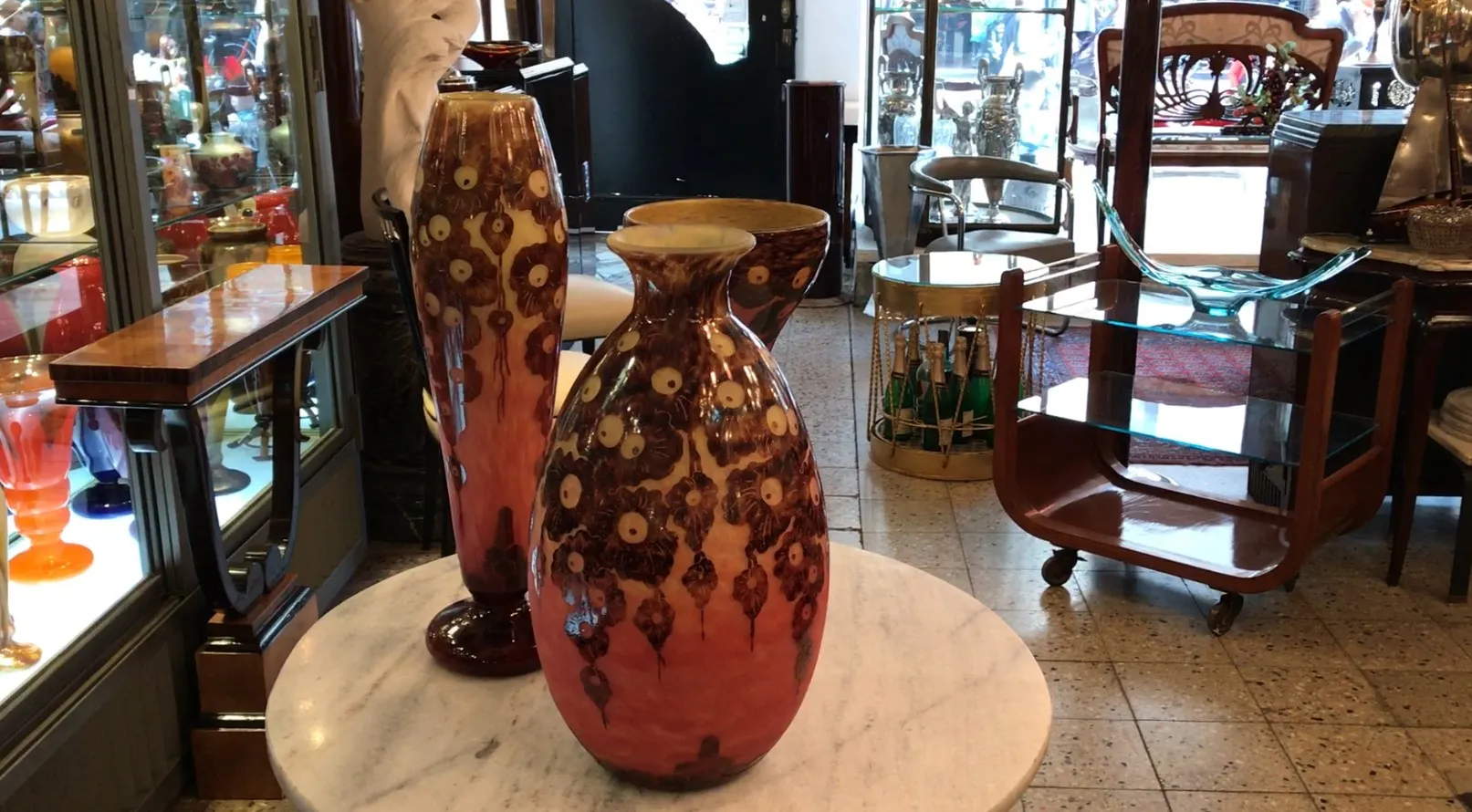 antique glass vases with floral design in a shop