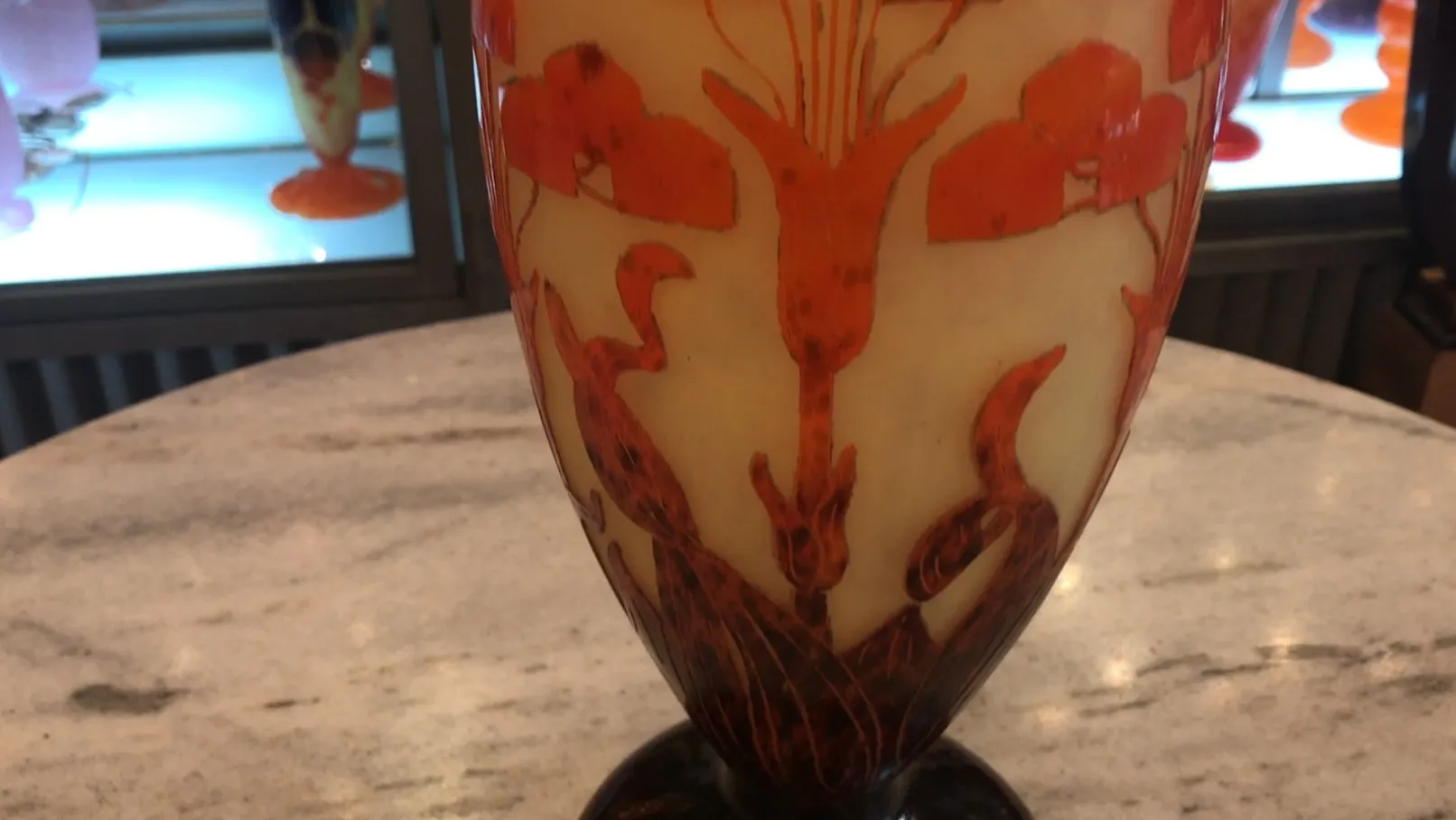 Antique signed glass Le Verre with floral design in orange hues.