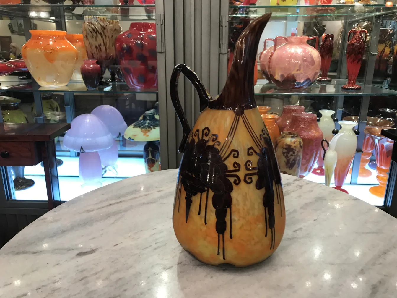 Antique pitcher with elegant design in an antique setting.