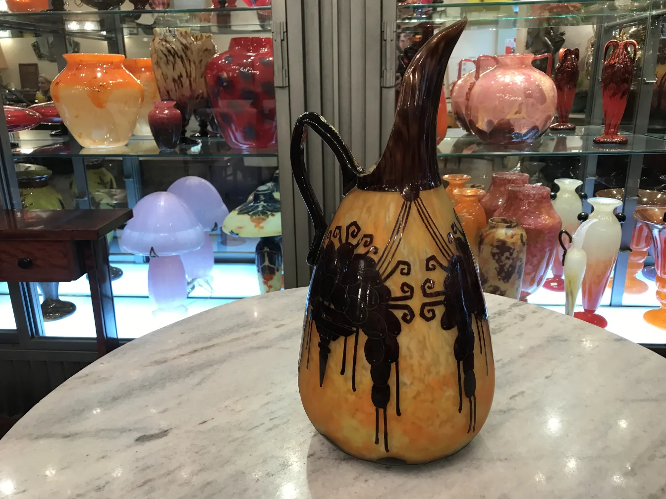 glass jug featuring an antique design and distinctive shape.