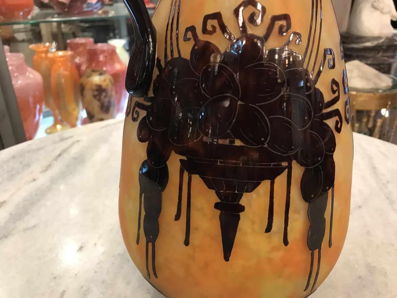 Antique glass with decorative details and warm colors, signed.