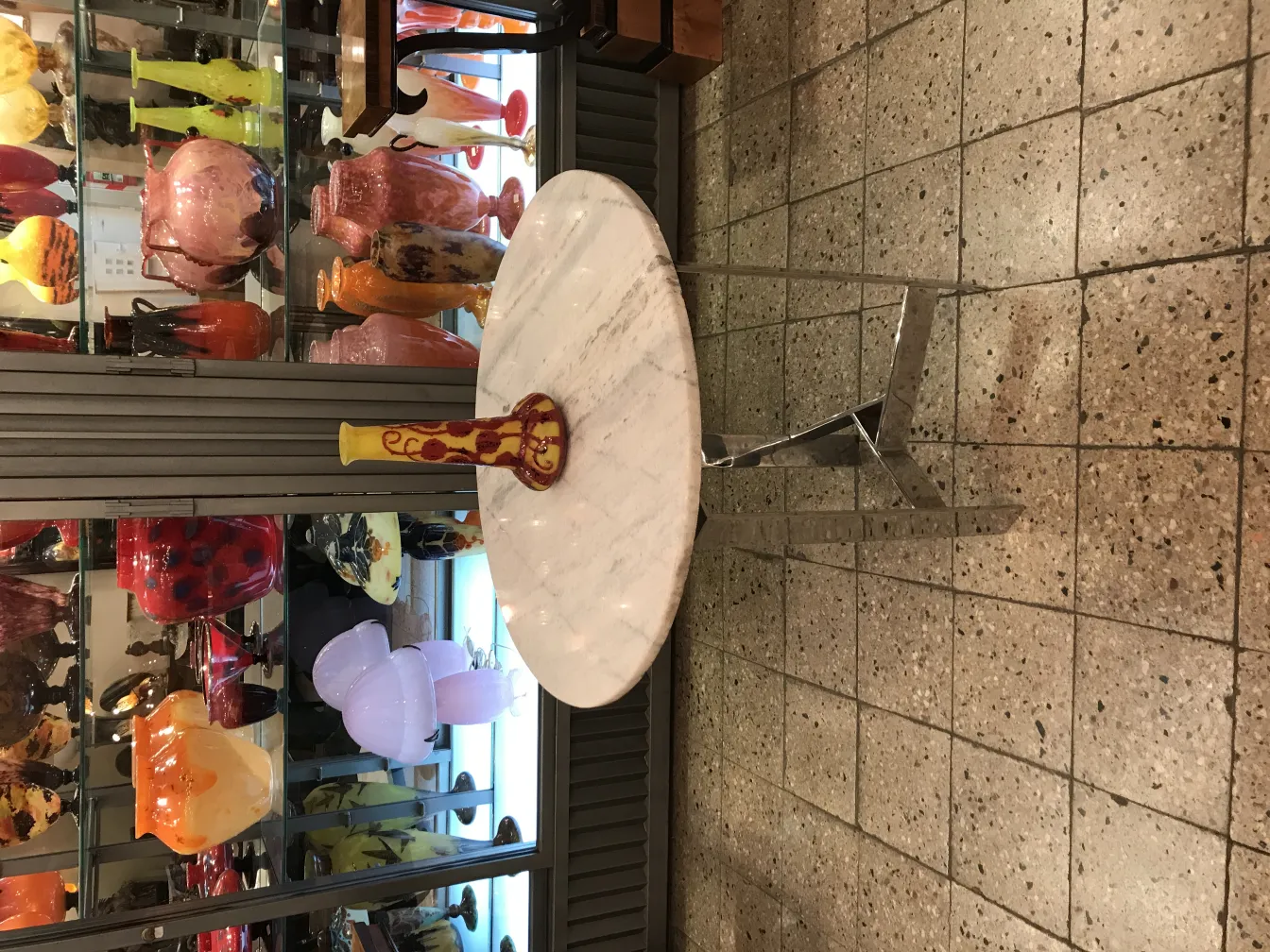 Antique glass vessel with signature, in a colorful setting.