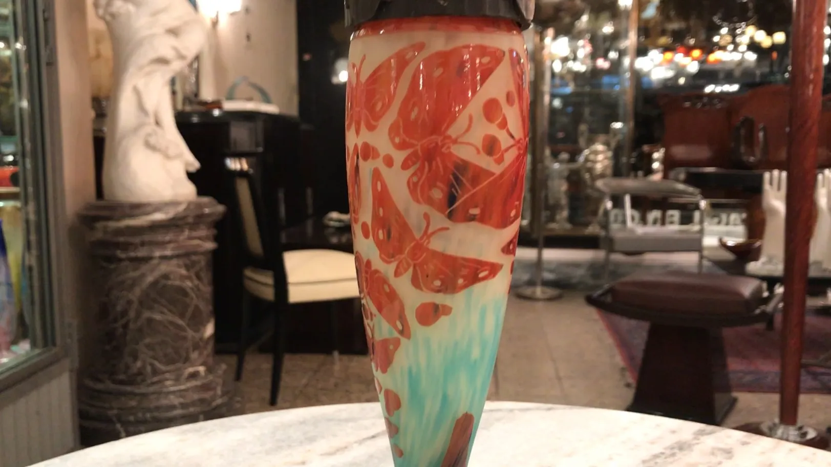 Antique glass featuring red butterflies on a light background