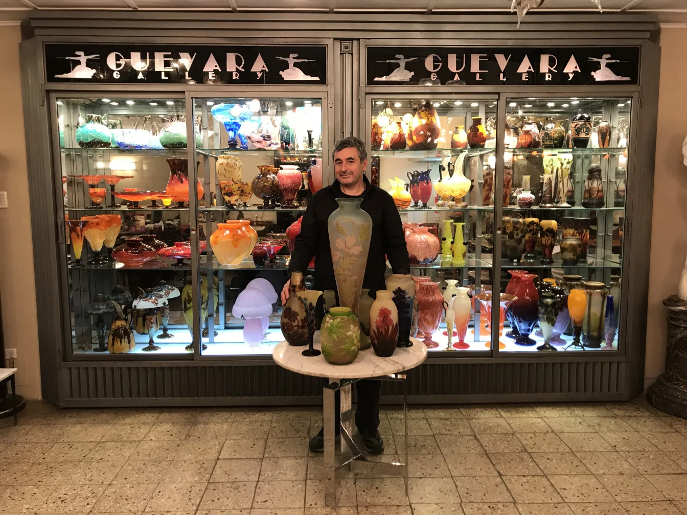 SIGNED GLASS Gallé surrounded by colorful jars in gallery