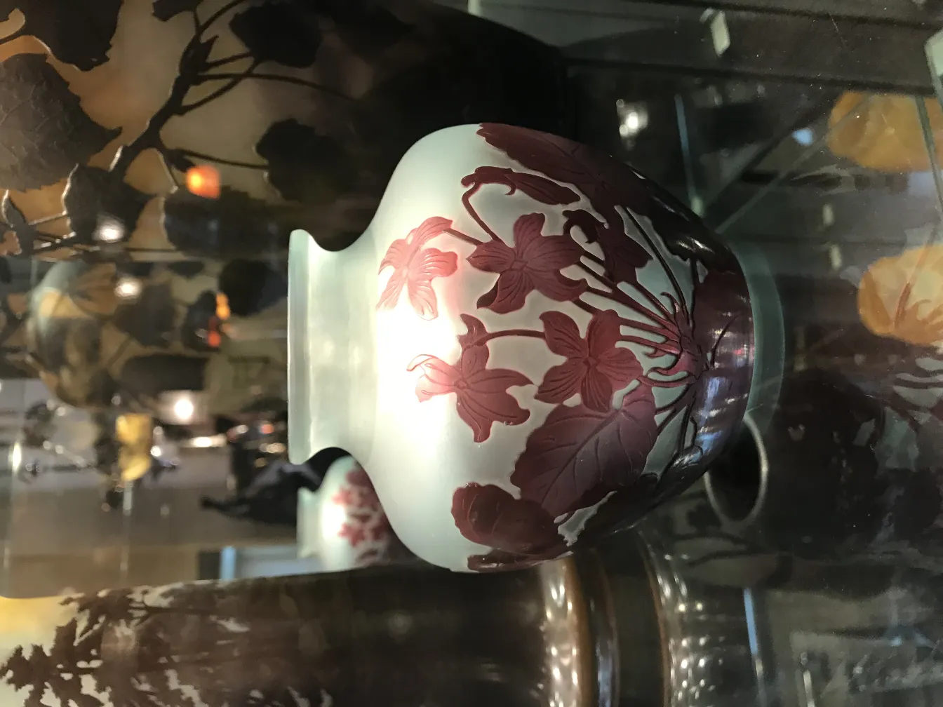 Antique signed glass Gallé with floral decoration on display.