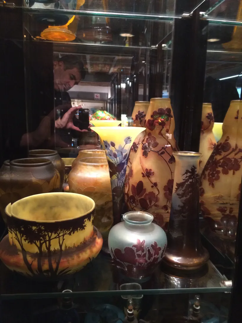 Antique signed Gallé glass with floral designs in a display case