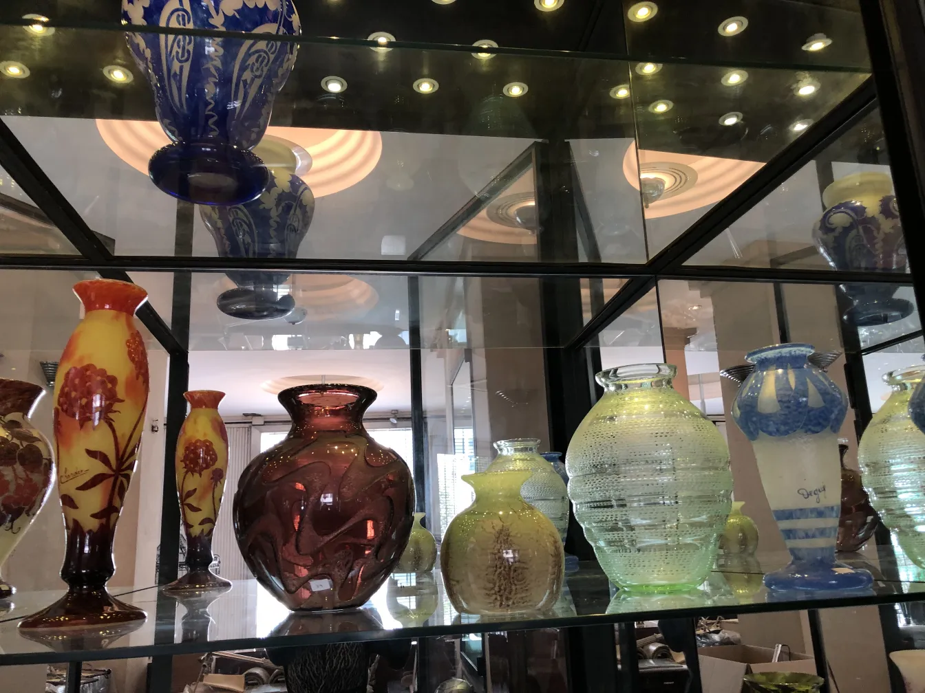 beautiful signed glass with flowers and various colors on shelf