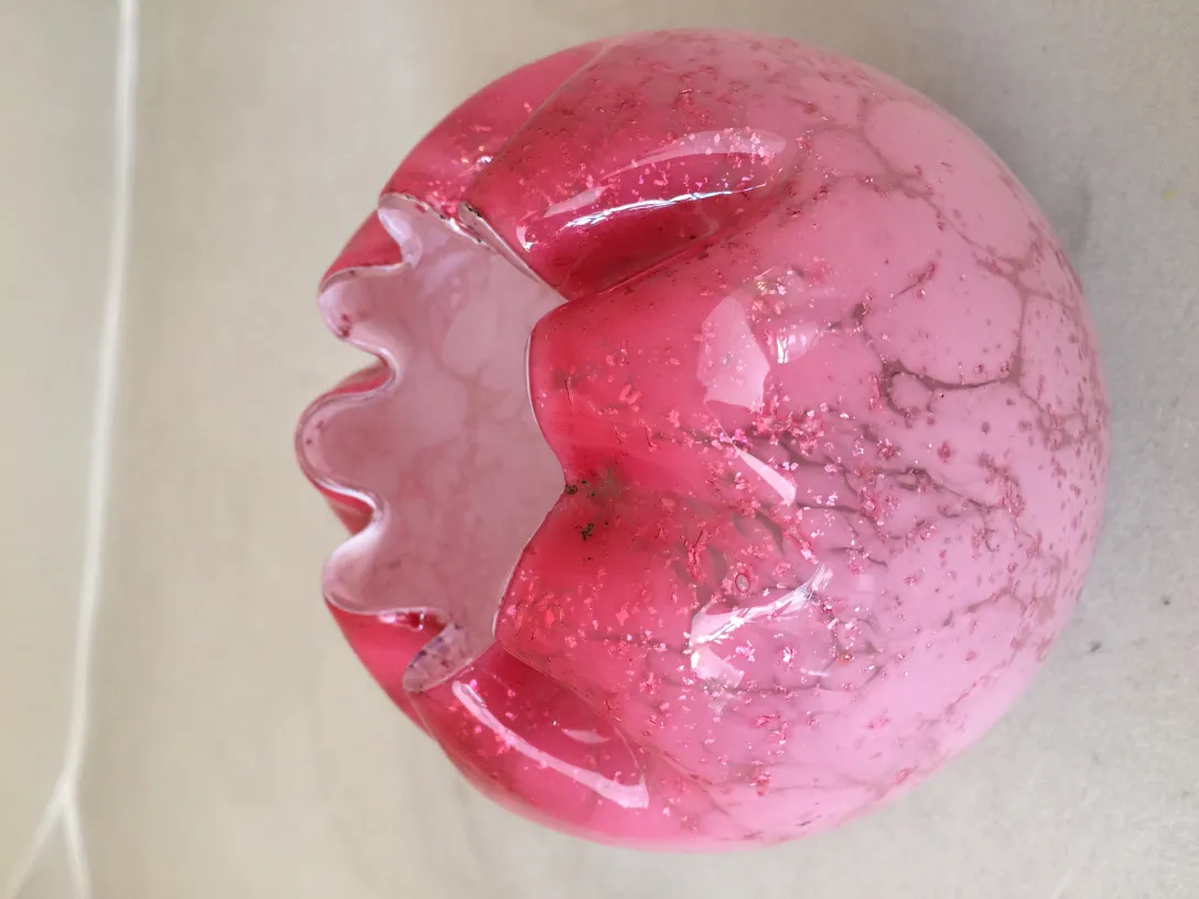 Antique signed glass in pink with unique design.