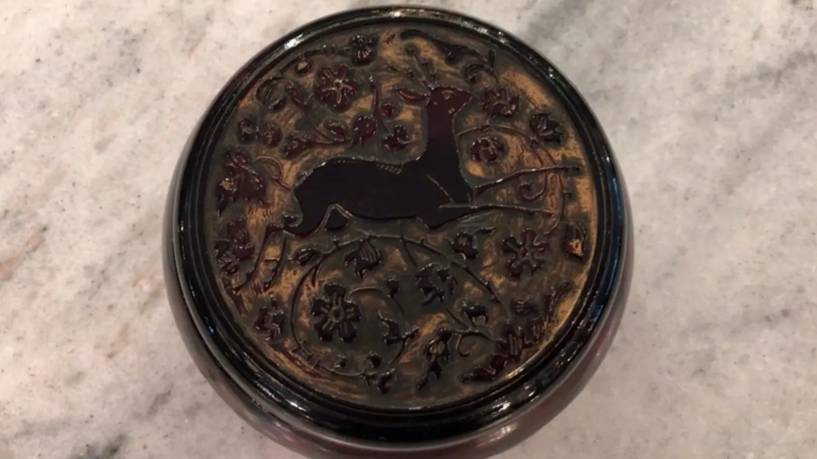 Signed glass displaying a deer and floral design, antique