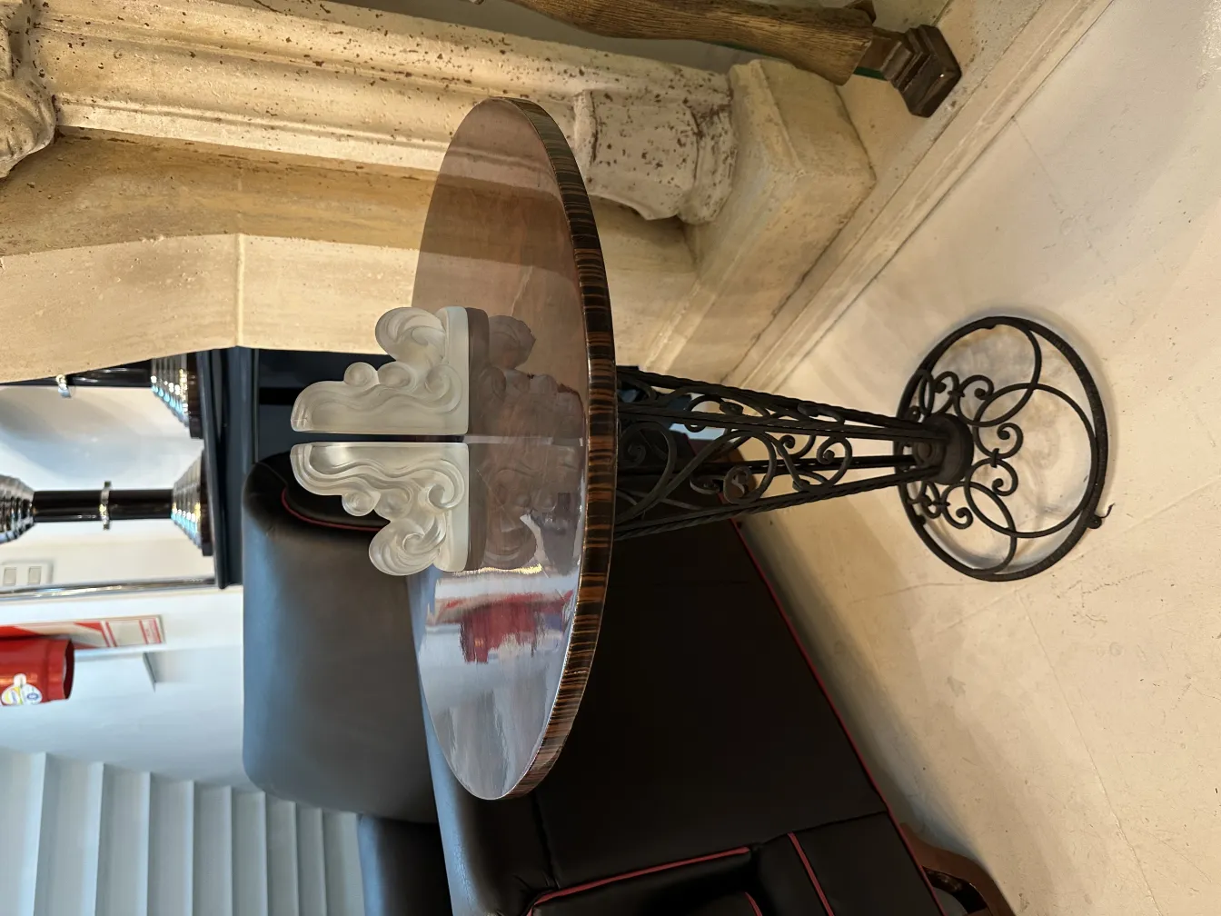 decorative table with signed glass and metal base in modern setting