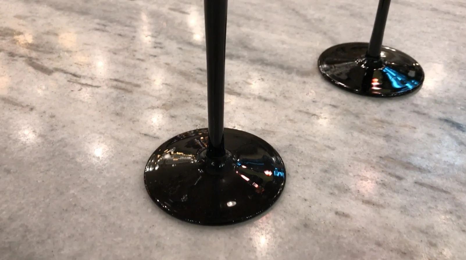 Antique signed glass with black base in a bright setting.