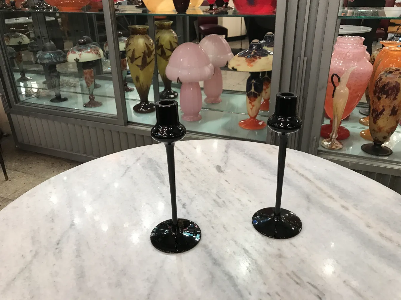 Black glass candlesticks with antique display background