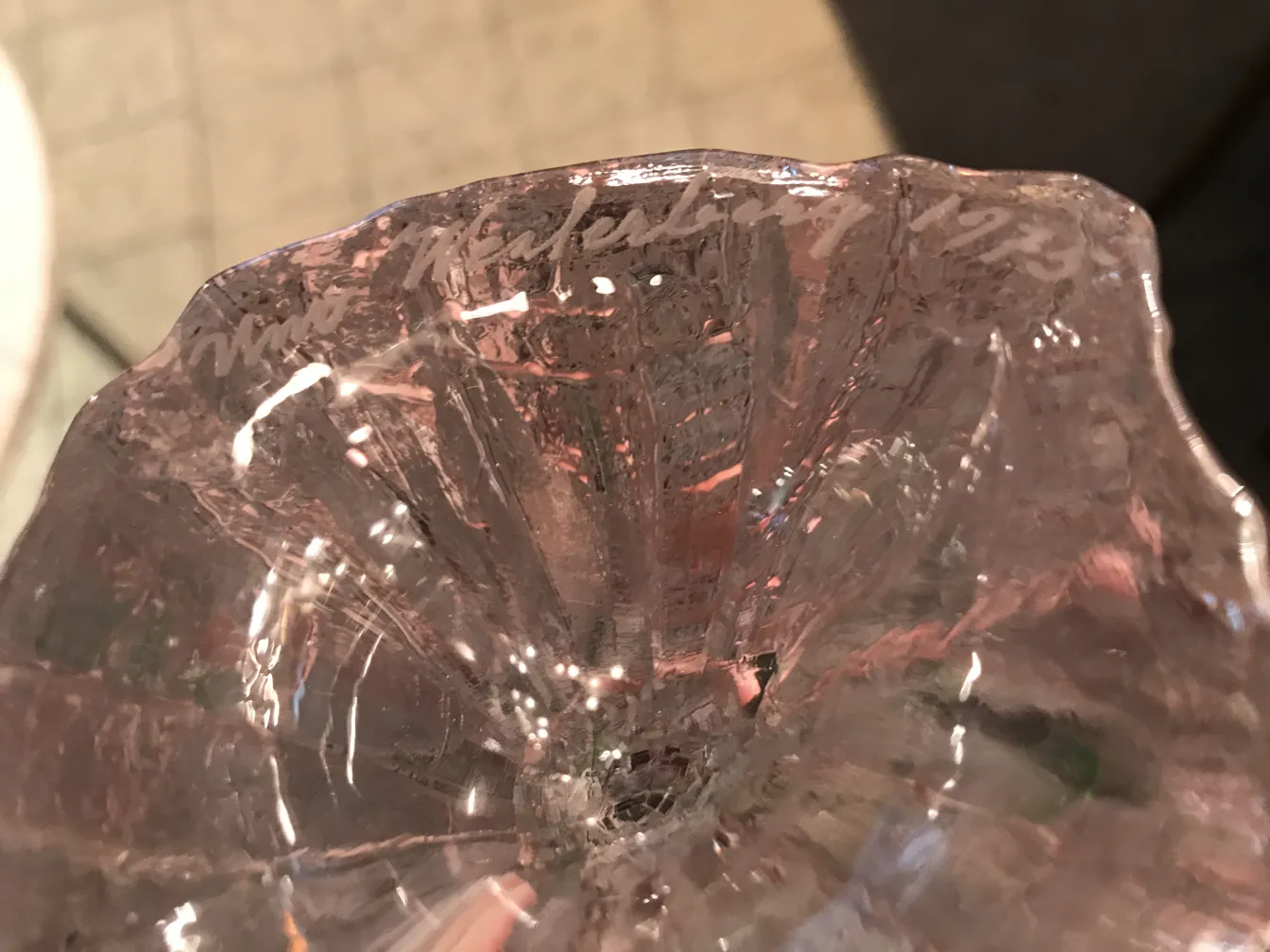 Antique signed glass with visible details and a signature on top.