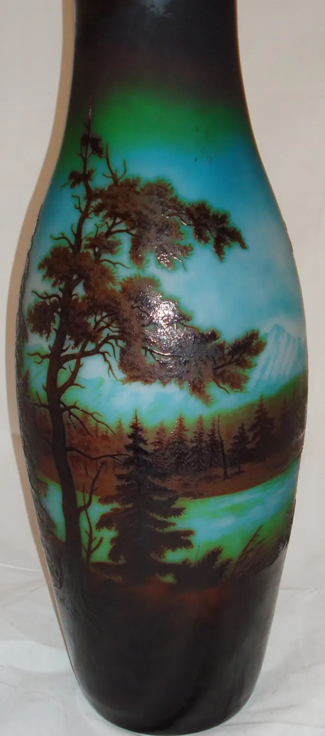 signed glass d'argental featuring tree and mountain scenery