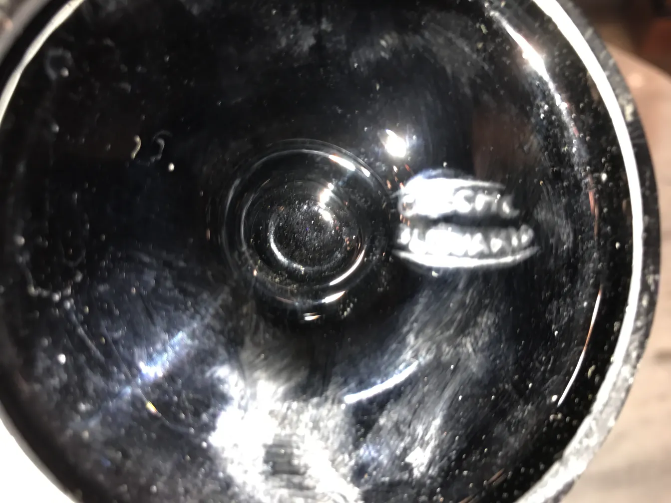 Details of an antique signed glass by Loetz, featuring a classic design and a visible signature on the base.