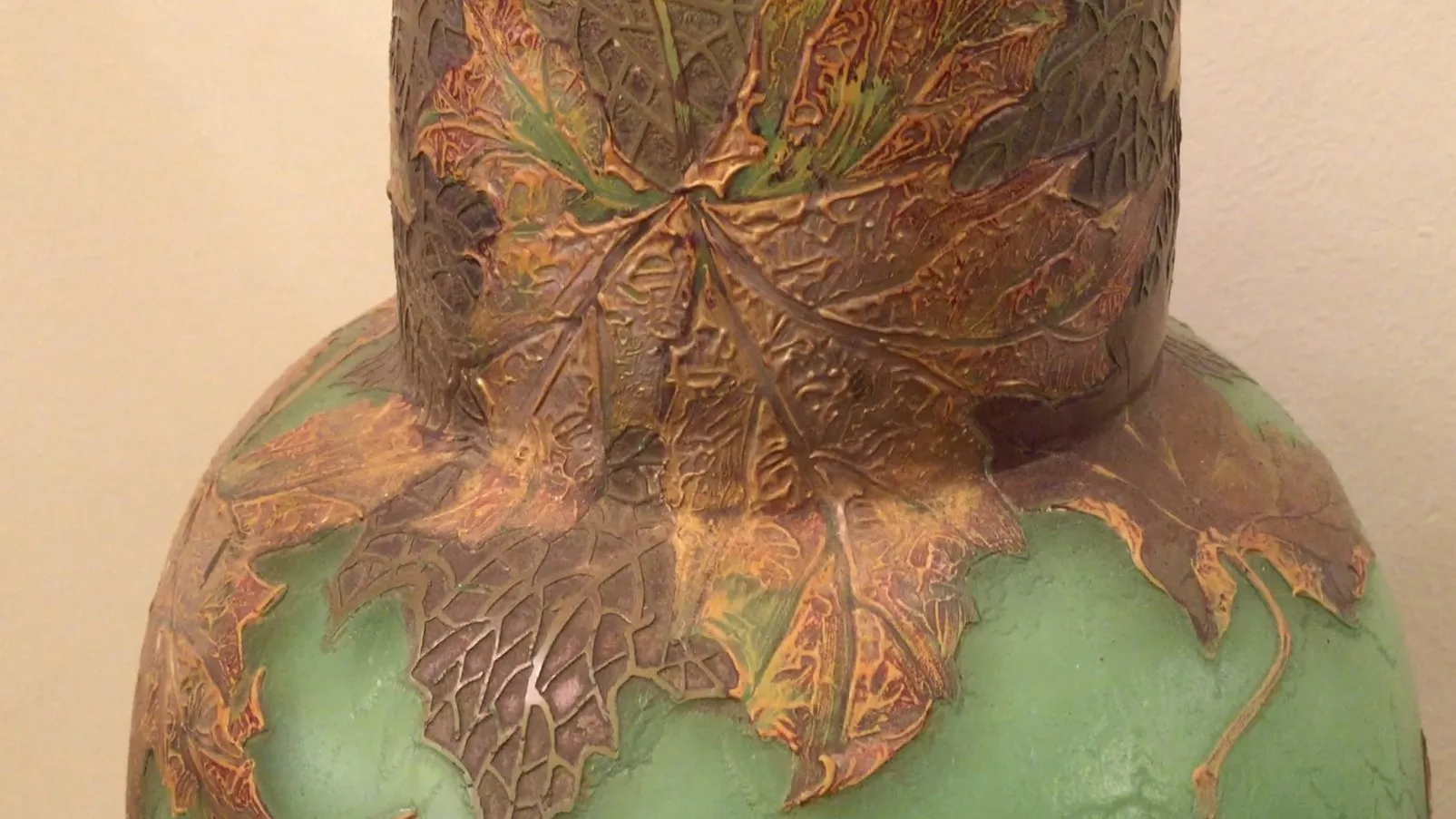 antique glass decorated with green and golden leaves