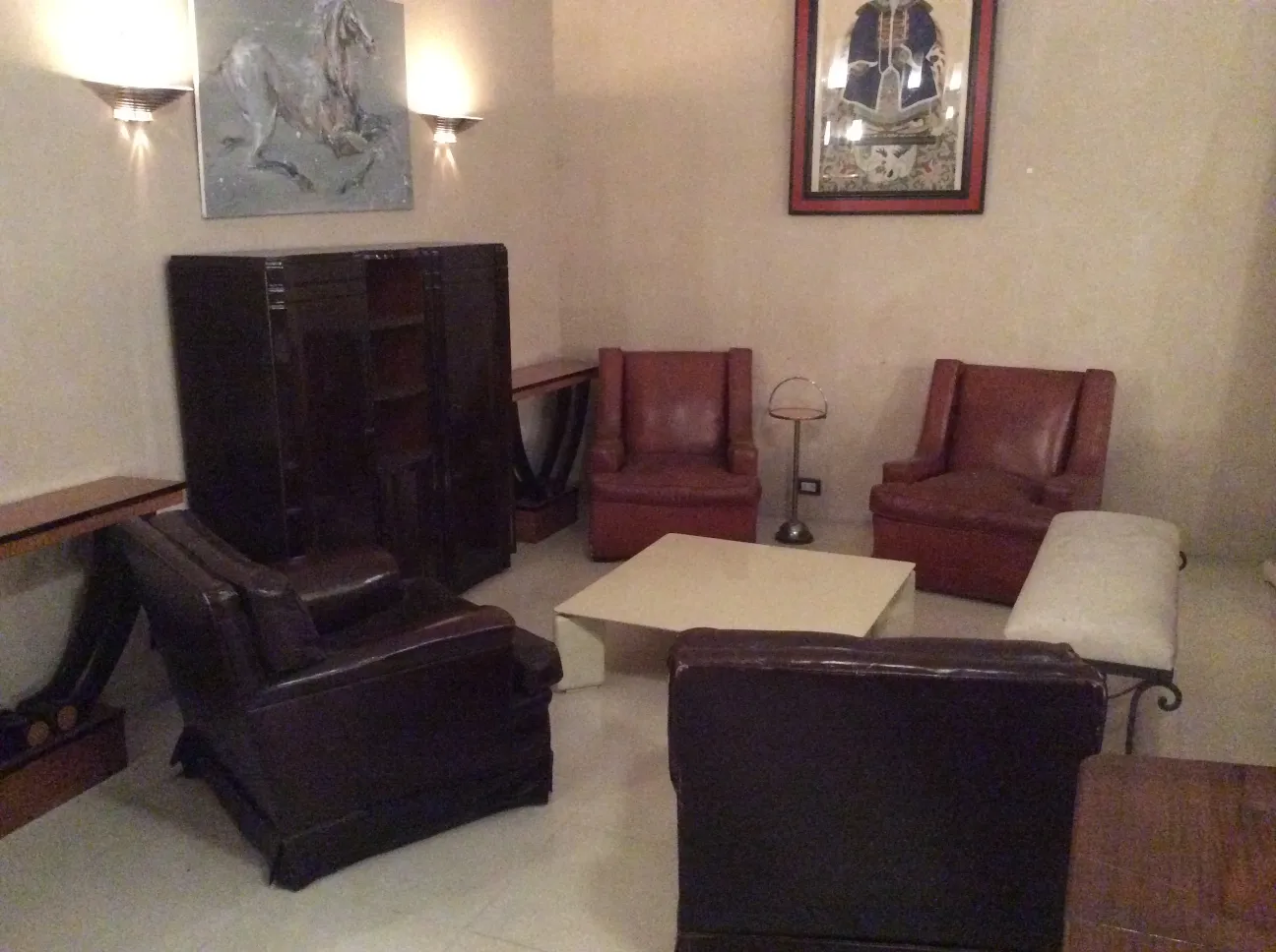 antique coffee table in a cozy setting with leather chairs