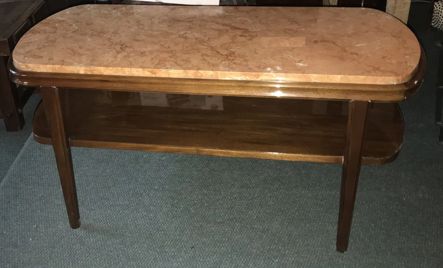 Antique coffee table with smooth surface and straight legs, decorative.