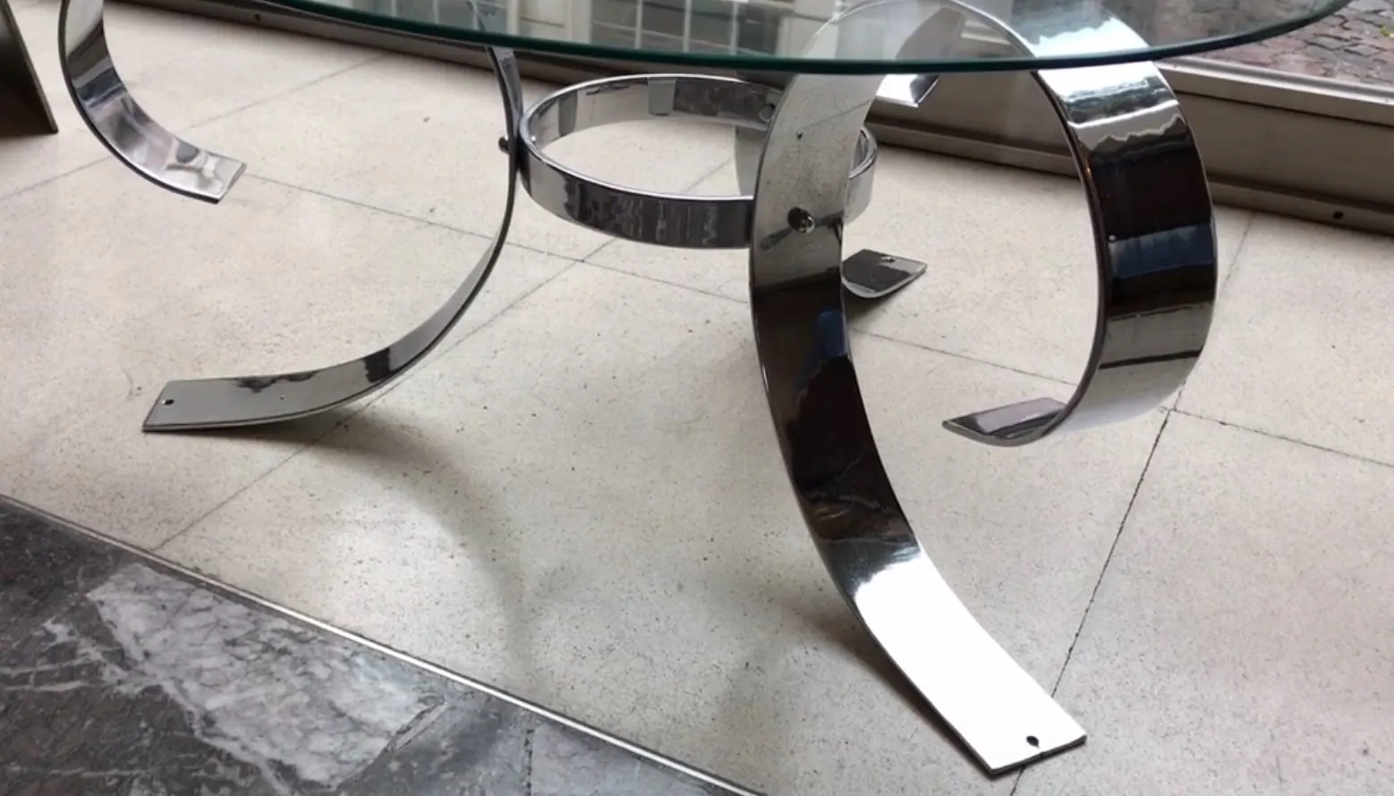 antique coffee table with curved base, modern setting