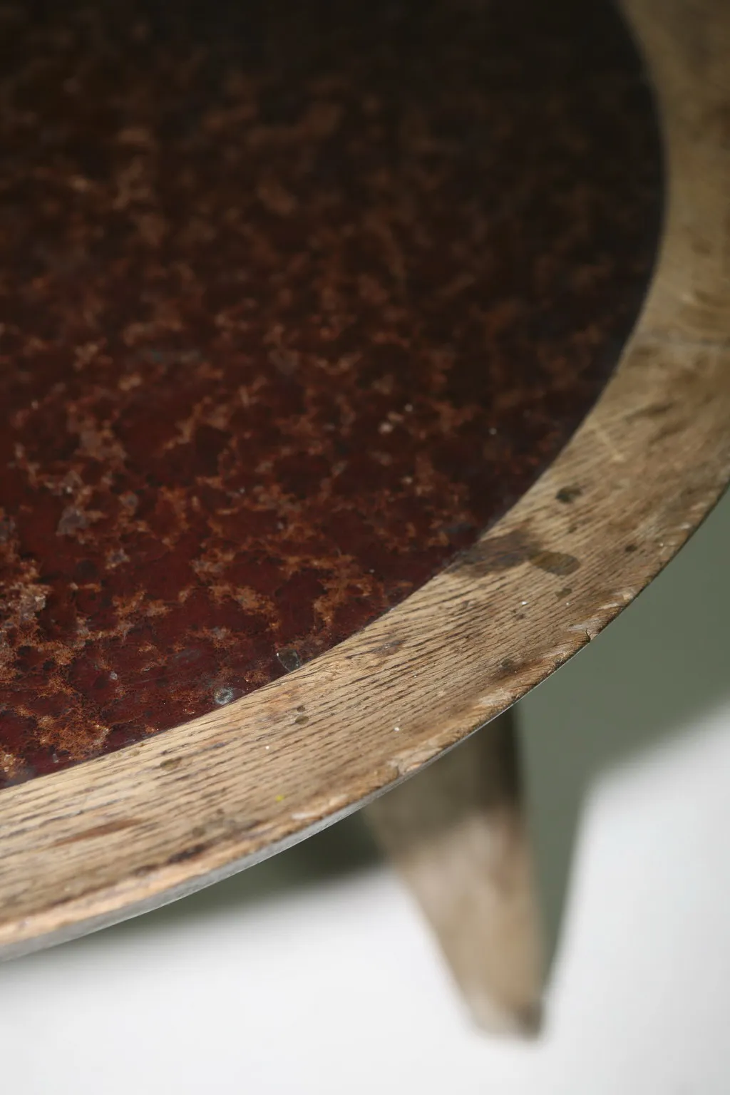 Antique coffee table with a round shape, featuring a brown surface and simple legs, set in a classic style.