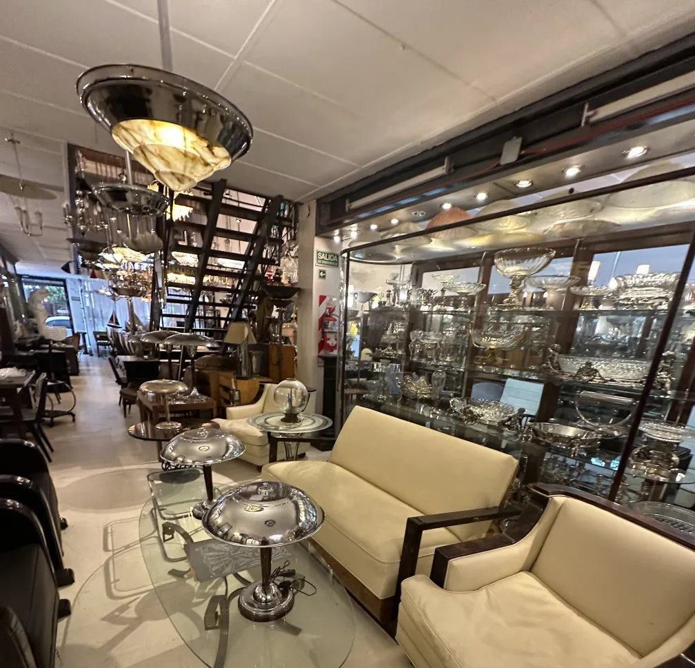 Antique coffee table with an elegant design in a vintage setting with chairs and decorative items