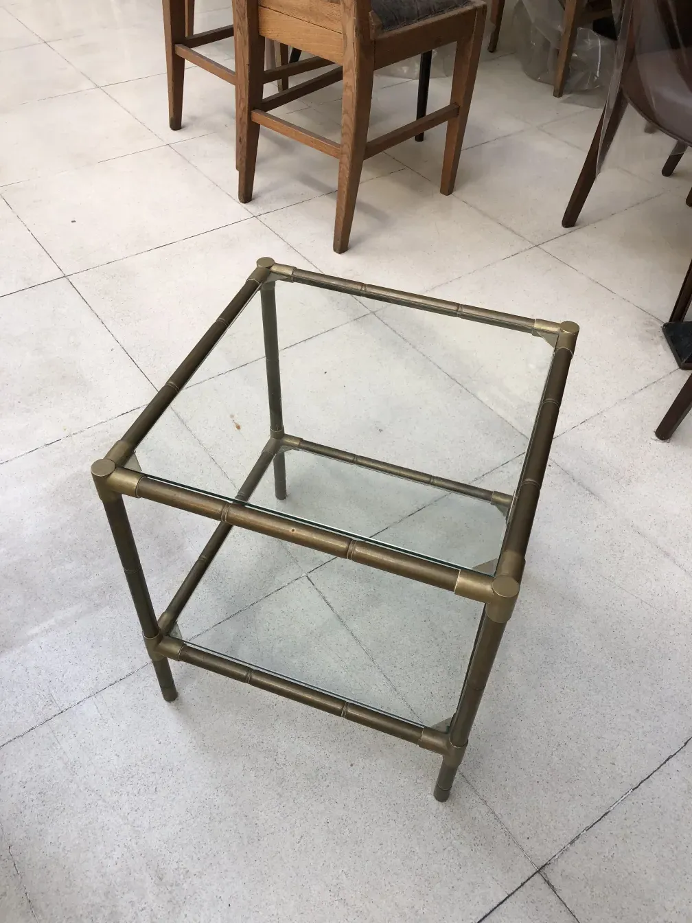 small antique table with gold base and glass top