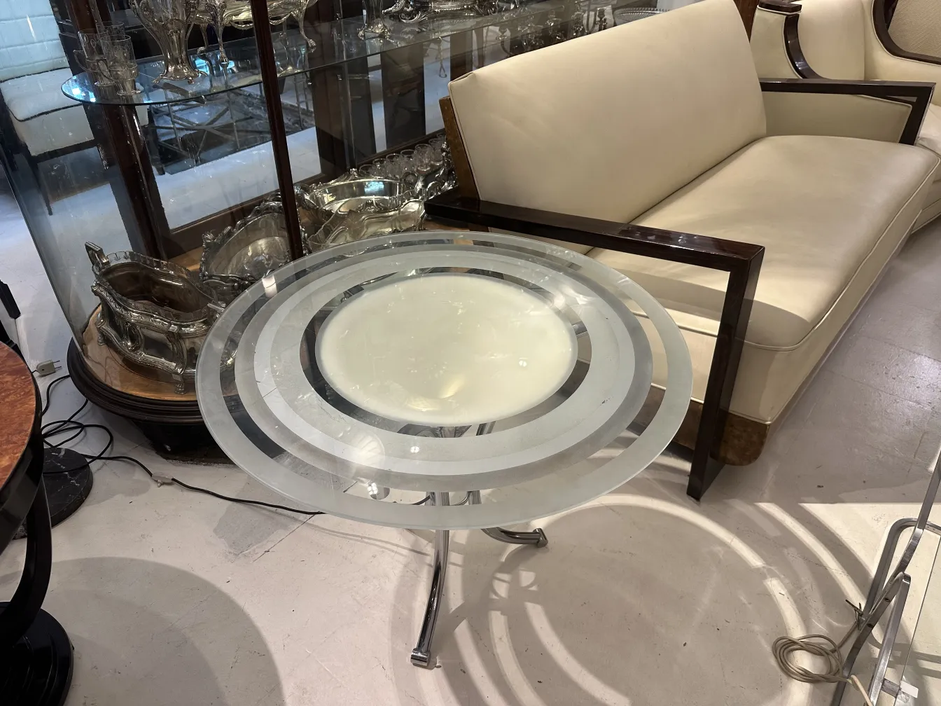 Antique small table with circular design, contemporary setting, elegant minimal decor.