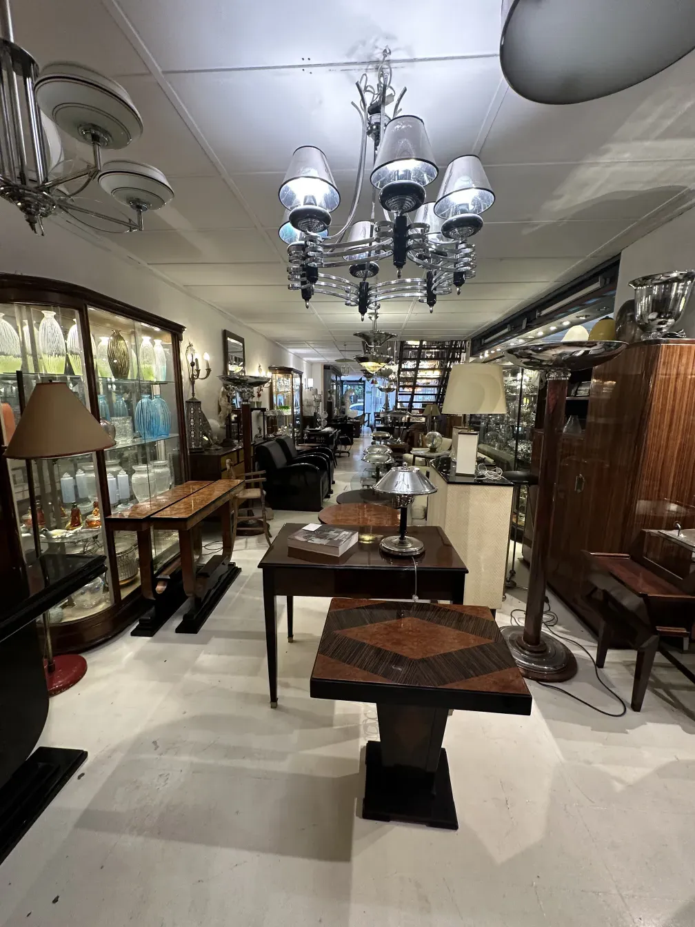 antique small table with intricate details and elegant design, surrounded by antiques