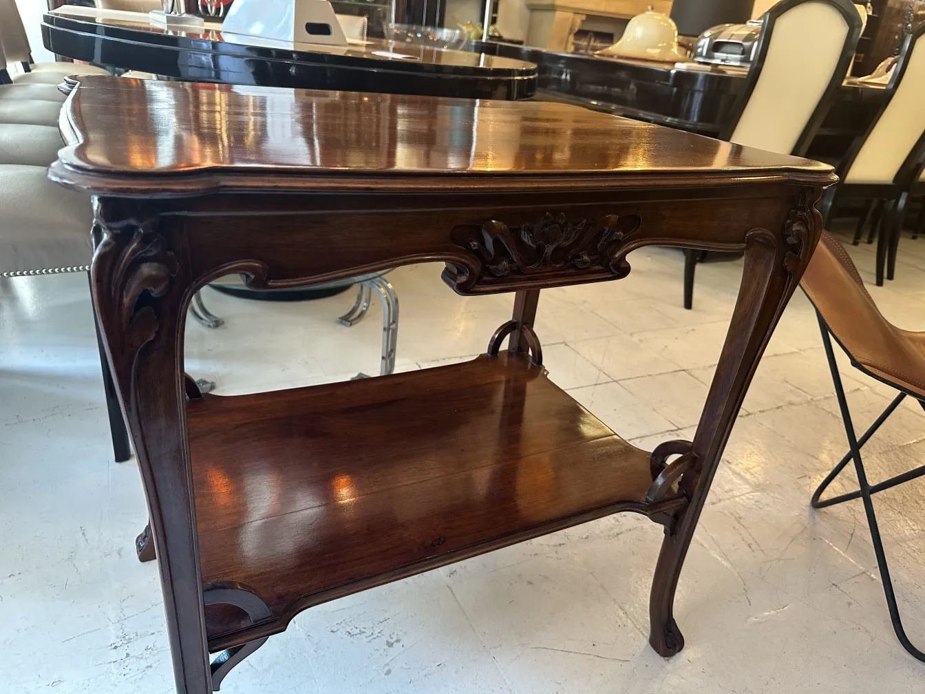 Antique small table with decorative features and a lower shelf