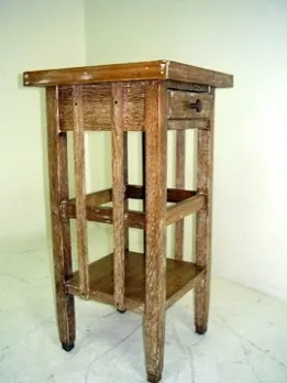 Antique small table with a drawer, light color, three shelves.