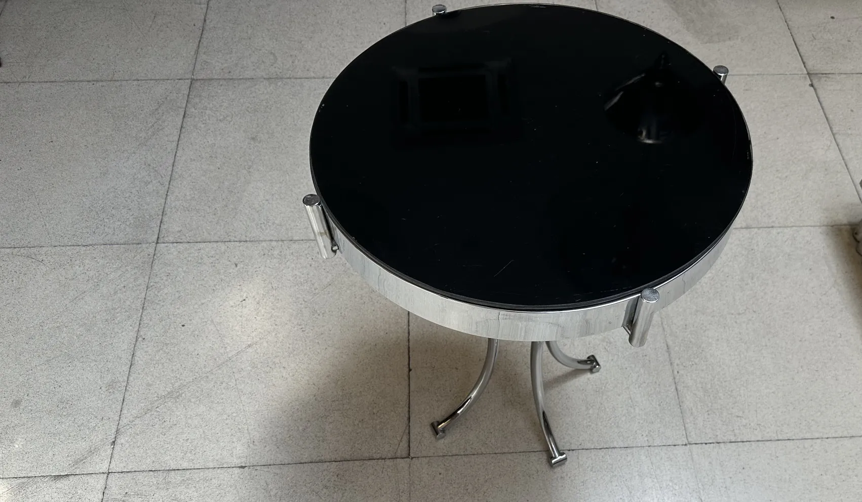 antique round small table with a shiny black top