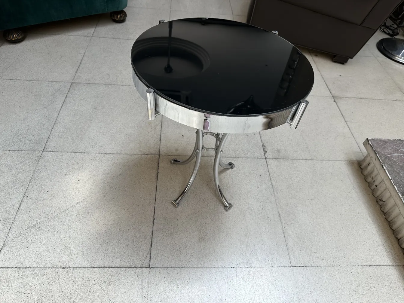 Antique black round table with silver details, decorative and elegant.