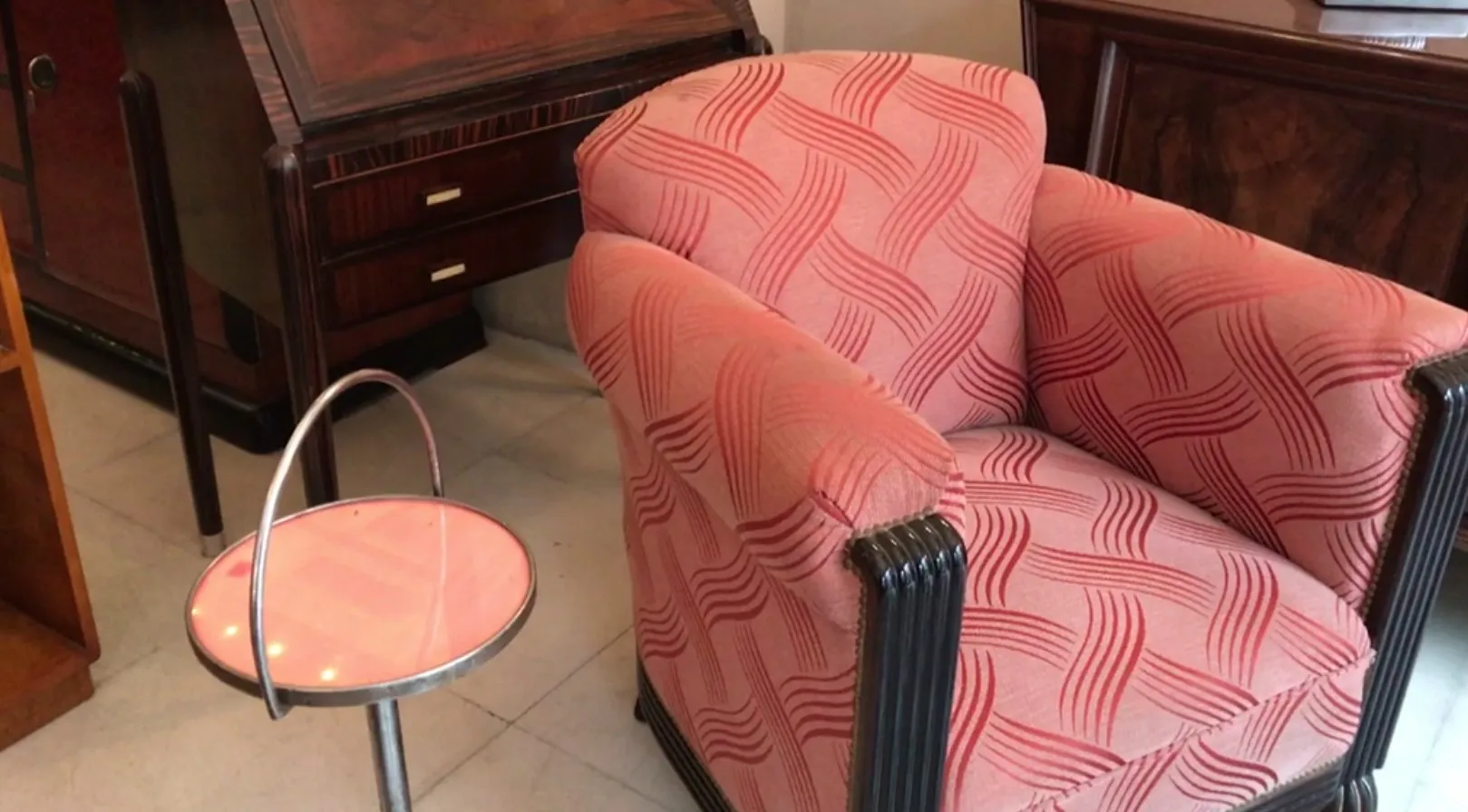 small antique table with round design and metal base, in an antique setting