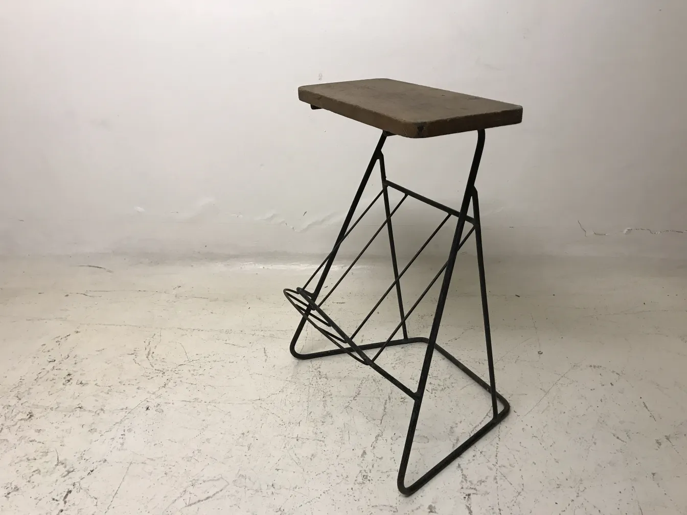 antique small table with metal legs and a rectangular top