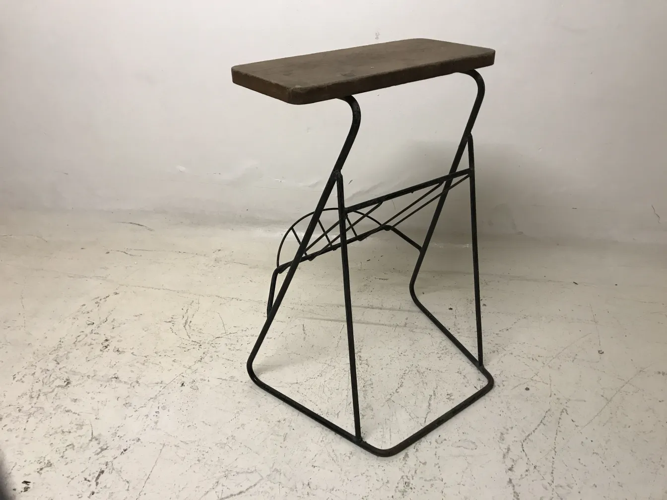 Antique small table with flat surface and triangular metal base