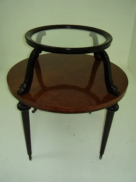 Antique small table with round glass top, elegant legs, neutral background