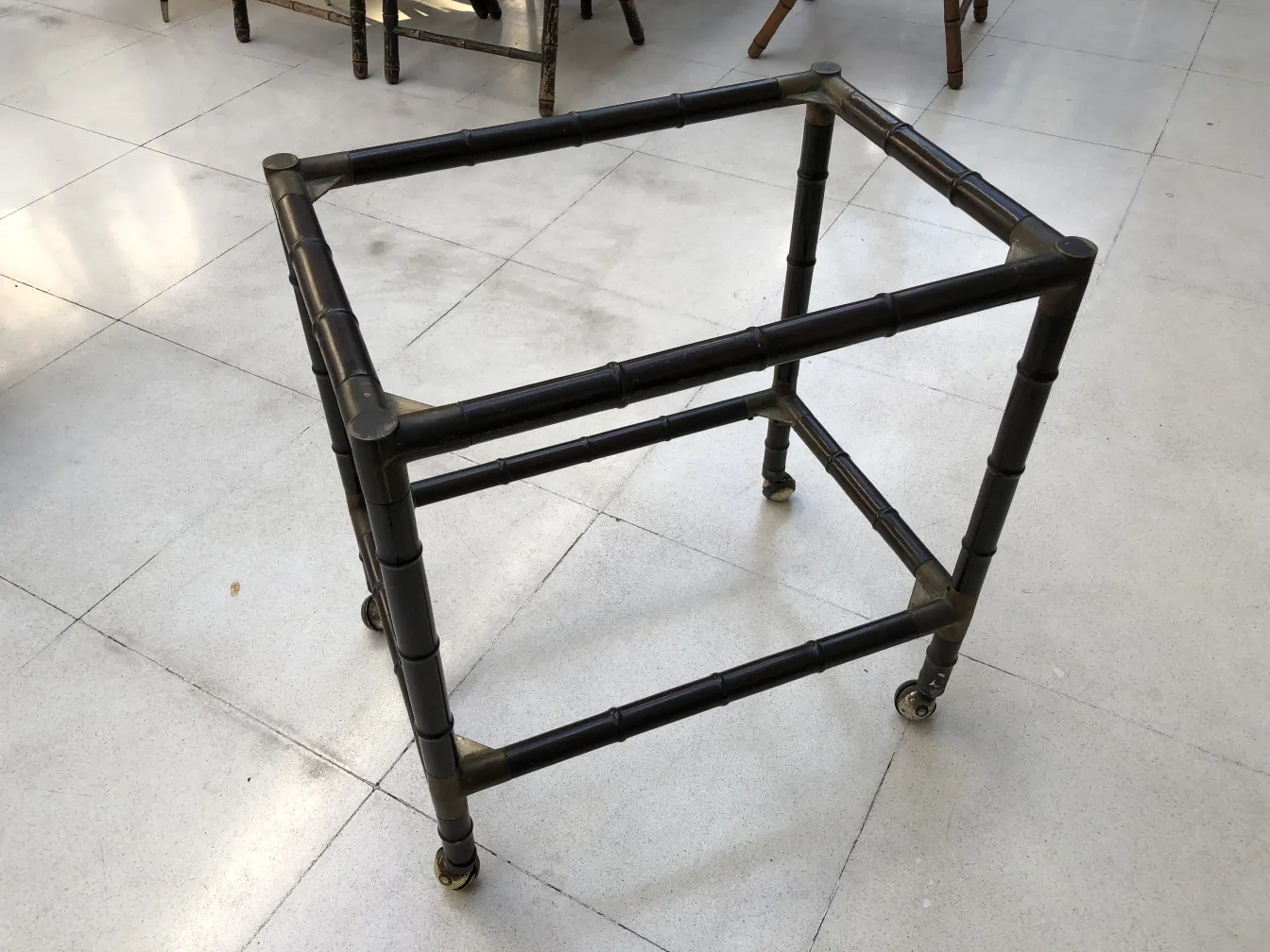 Small antique table with wheels in a bright setting